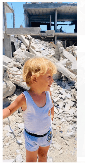 Toddler standing infront of Rubble