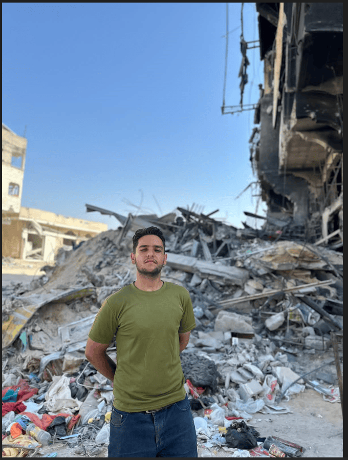 Man posing in front of Rubble