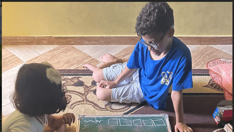 2 Children Sitting on the Carpet Playing