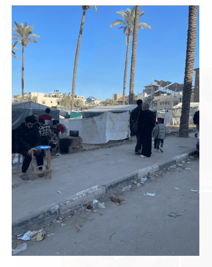 Palestians in the street beside their tents