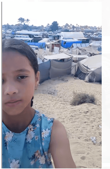 Child Selfie in front of tents